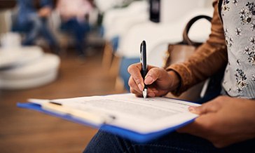 Person filling out paperwork