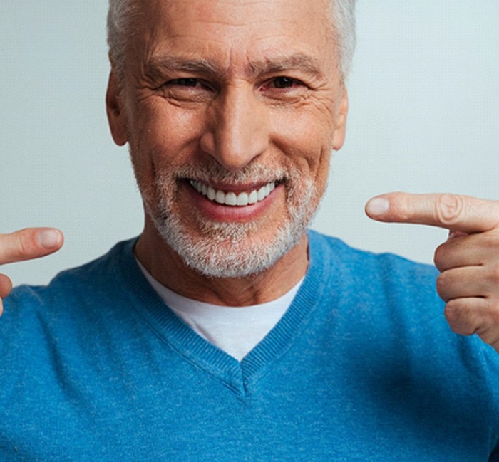 Man smiling after undergoing a root canal 